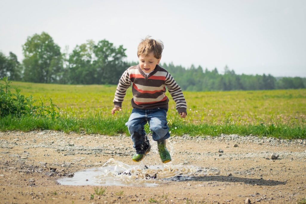 boy jumping near grass at daytime
बदलता बचपन 